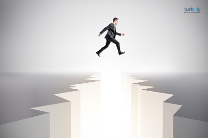 Businessman jumping over gap. Difficulty, challenge and overcome concept.