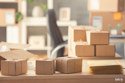 Parcel boxes and envelopes ready for shipment to client on table in home office