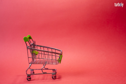 Tiny shopping cart on the red background