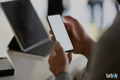 Cropped shot of young businessman looking at blank screen smartphone